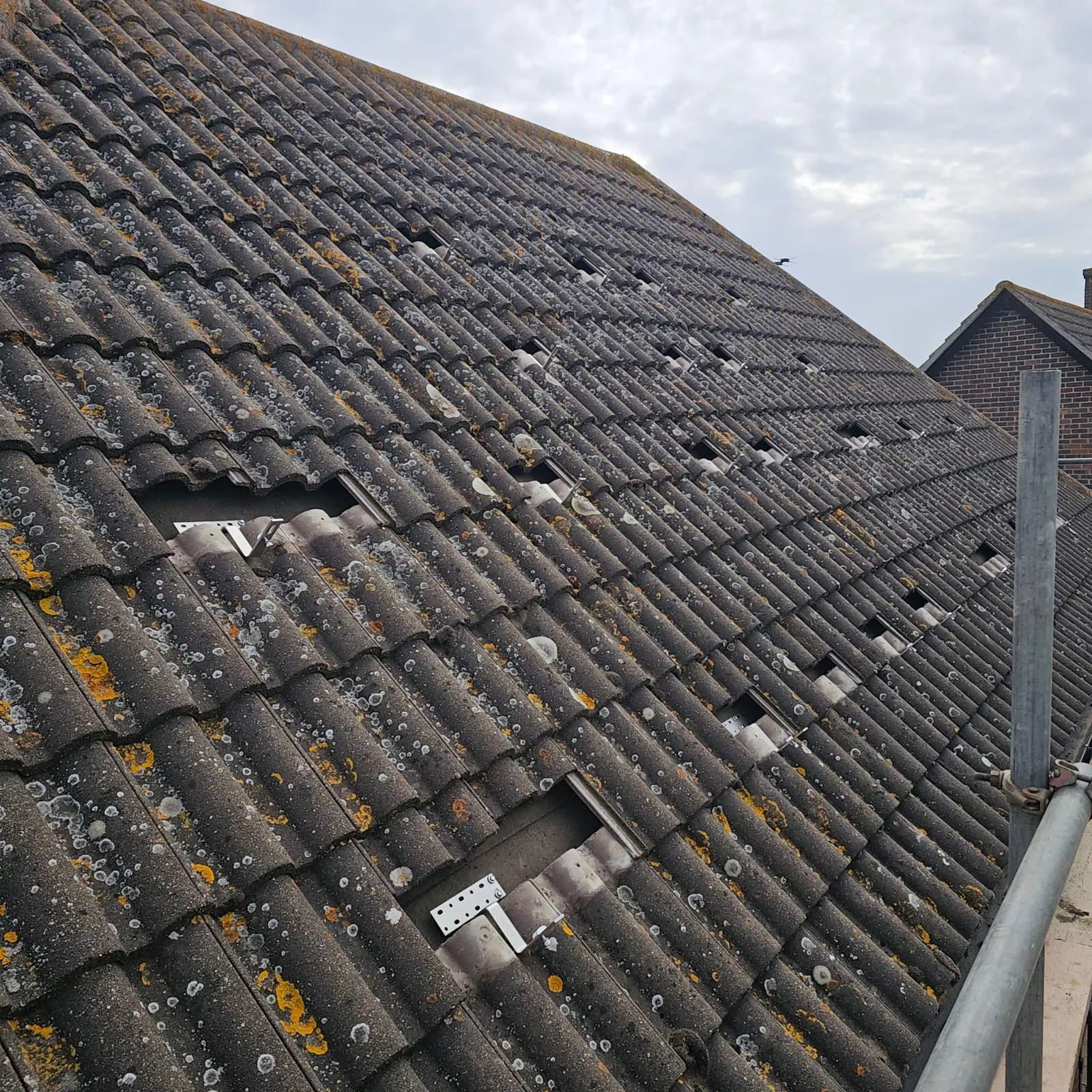 Solar panel mounting rails fixed onto an existing tiled roof