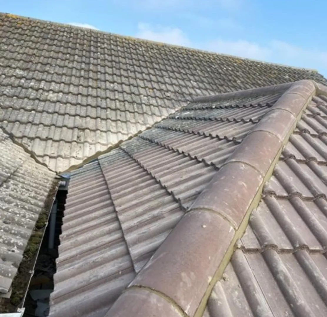 New ridge tiles fitted alongside older roof tiles